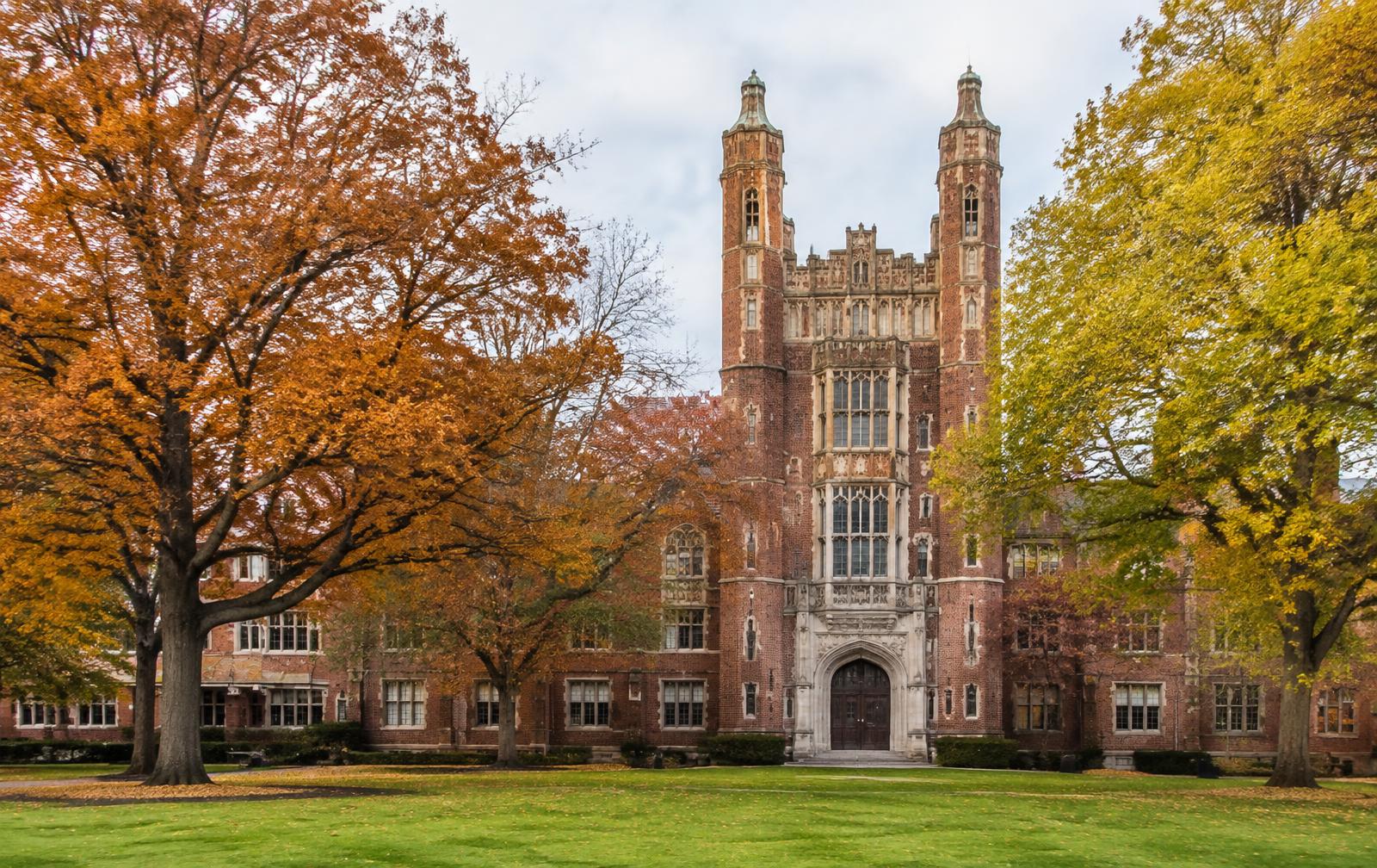 Red-brick Gothic college building on the Belmont Abbey campus in autumn